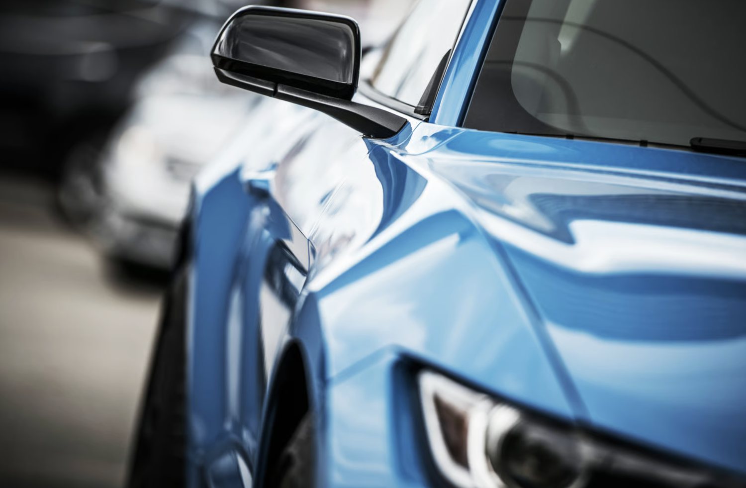 Close-up of a blue vehicle on the Reel Deal Auto lot