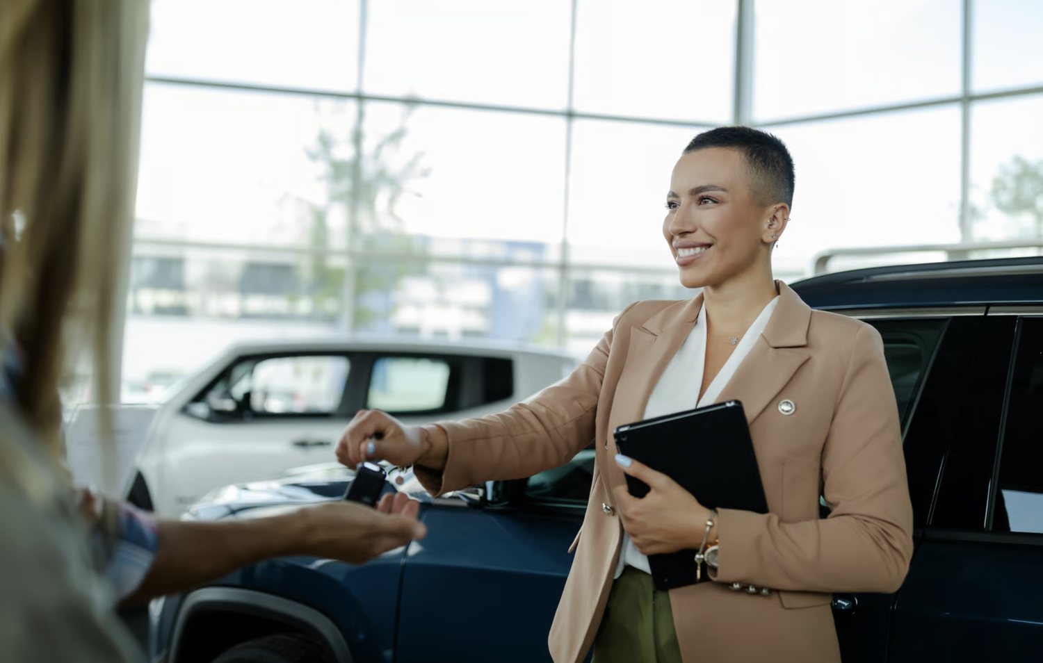 Reel Deal Auto salesperson handing car keys to a customer